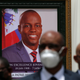 Authorities pose for a group photo in front of the portrait of late Haitian President Jovenel Moise at at the National Pantheon Museum during his memorial service in Port-au-Prince, Haiti. Moise was assassinated on July 7 at his home. Less than a dozen elected officials are currently representing a country of more than 11 million people.